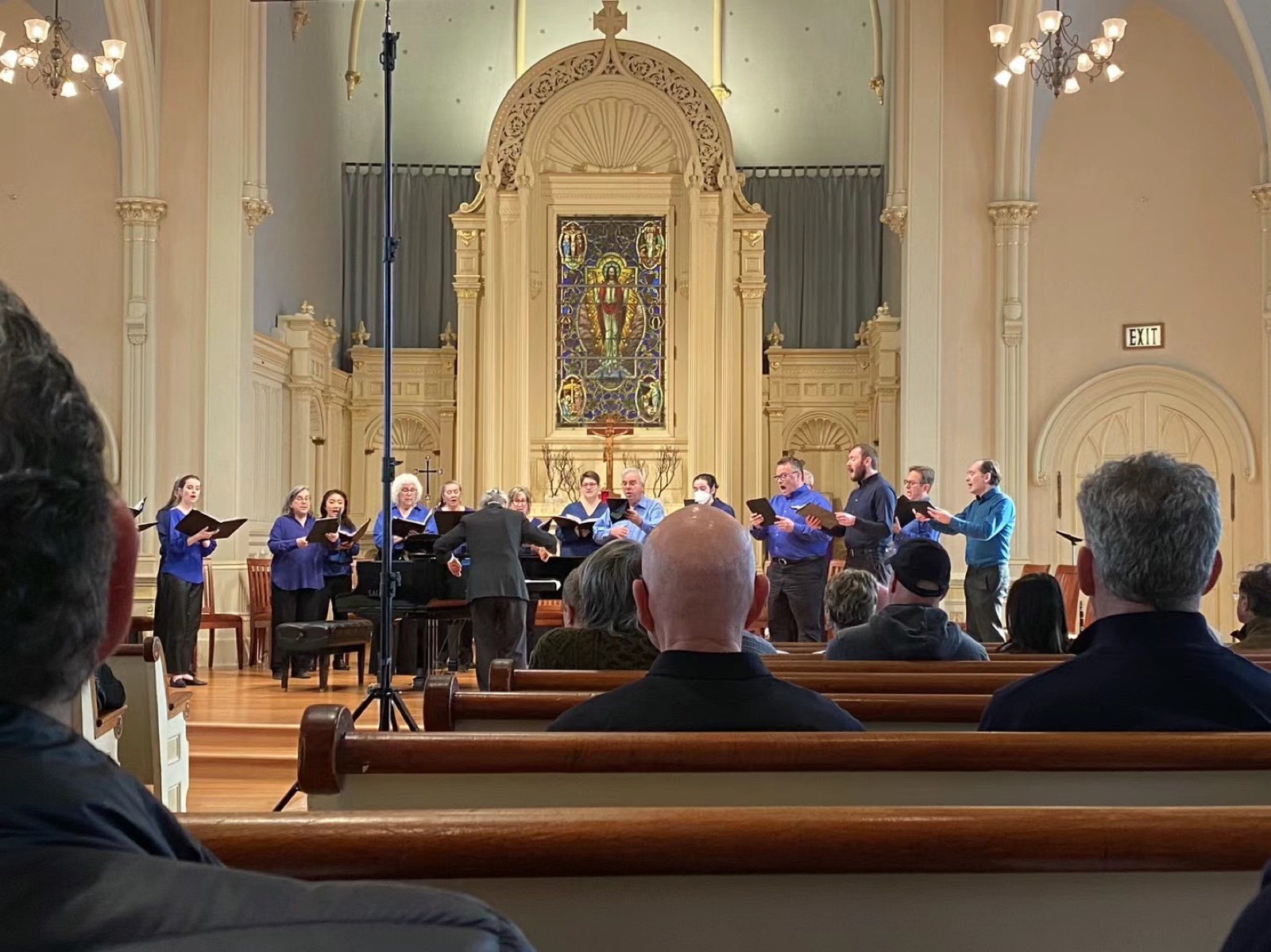 SATB choir performing in a stained-glass church